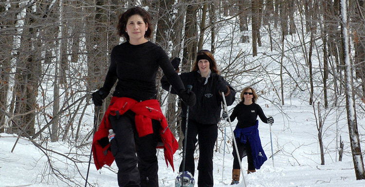 Girls ski trip can mean downhill skiing or cross country skiing on a winter girlfriend getaway - three women in woods at Seven Springs, one of many PA ski resorts #SkiPA