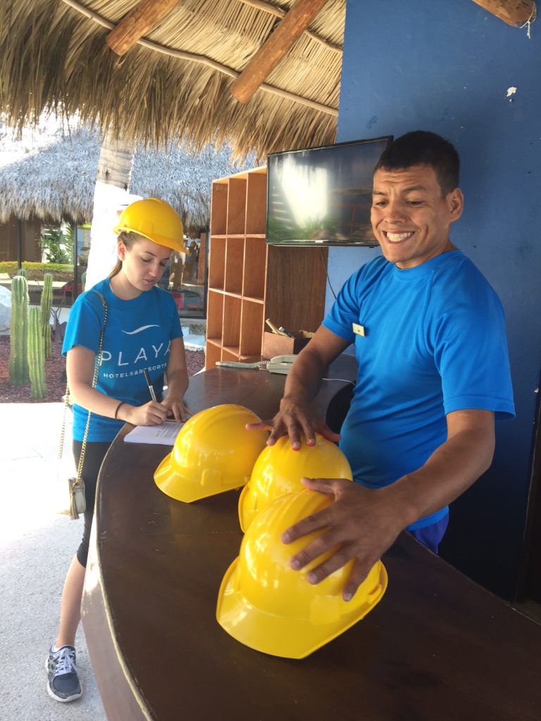 Hyatt Ziva Puerto Vallarta activities desk signs up a guest for the jungle walking tour. 
