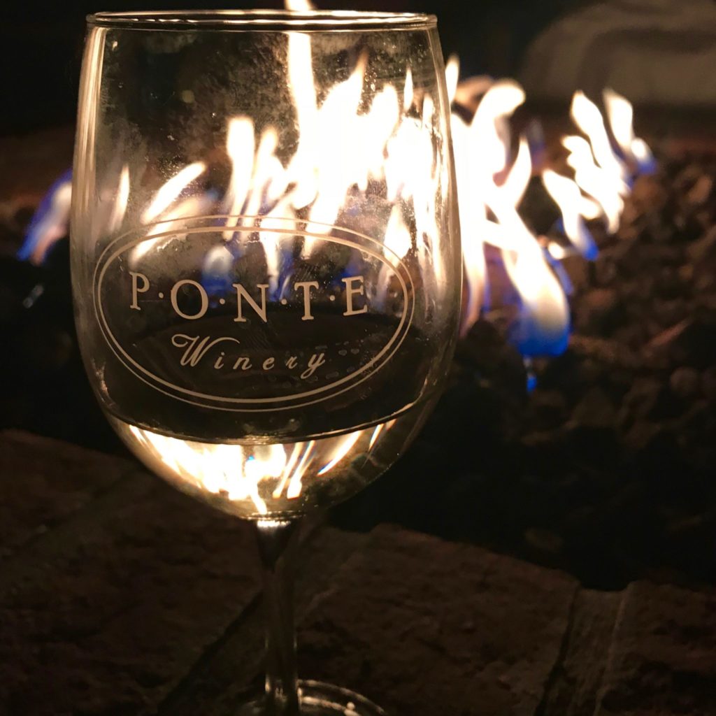 A glass of wine by the fire at the Ponte Vineyard Inn.