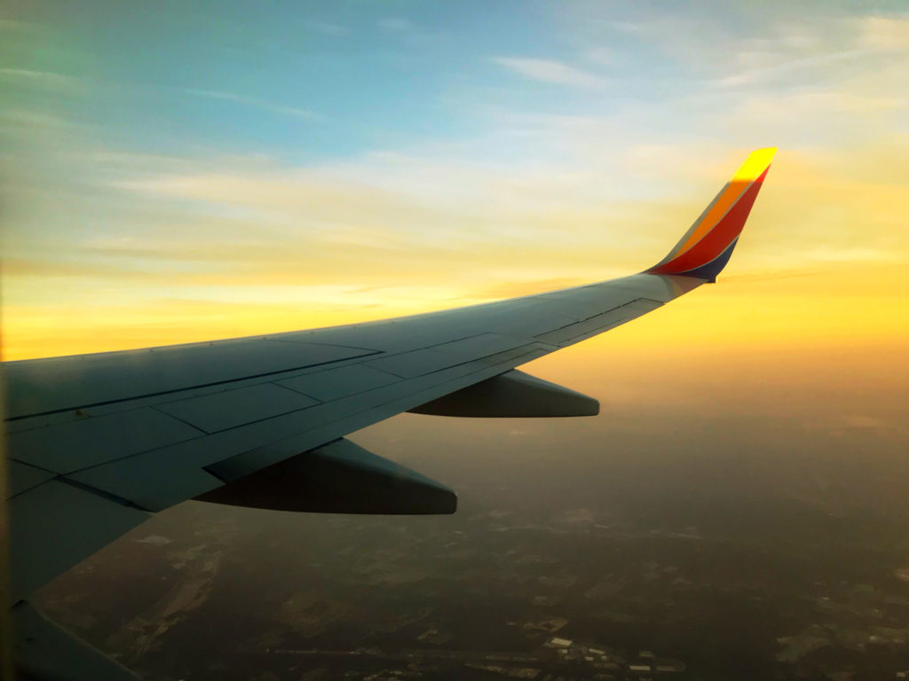View of an airline wing as the sun sets.