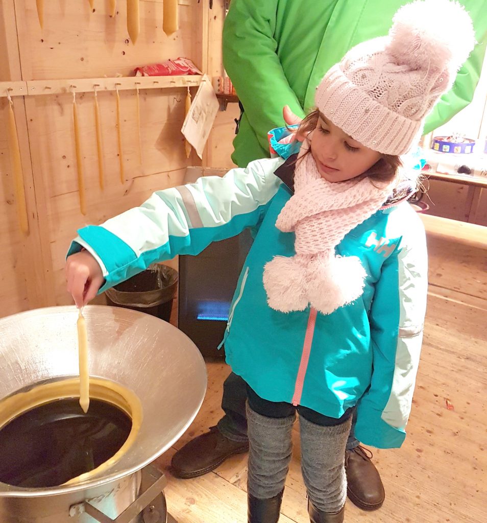 A child making a candle at a European Christmas market.