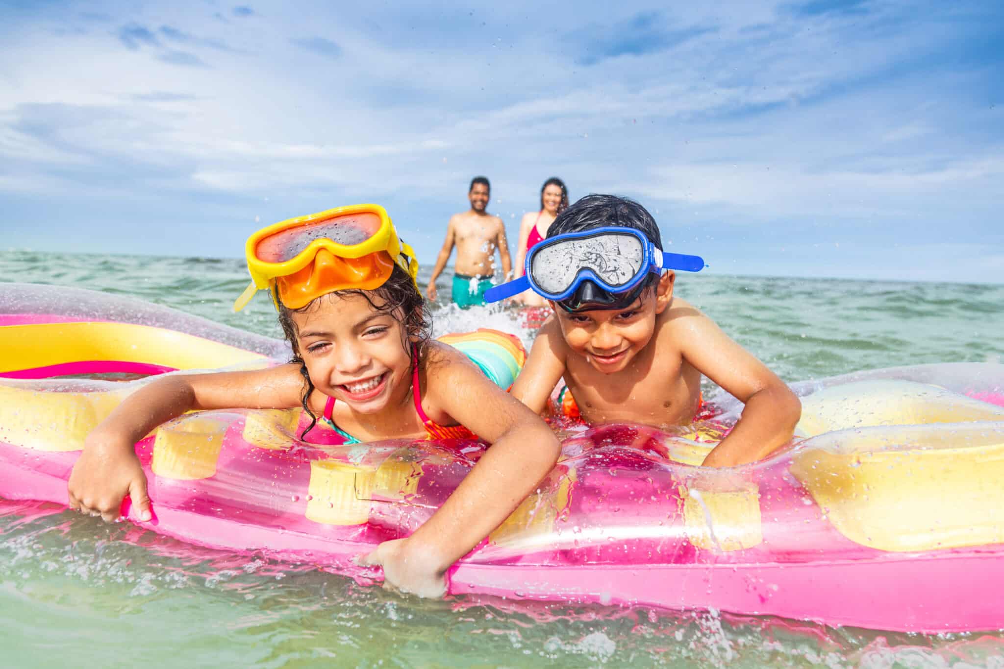 Kids swimming in the ocean in Florida