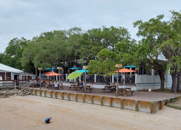 a child playing on the beach in front of Aunt Kate's, a family friendly St. Augustine restaurant. 