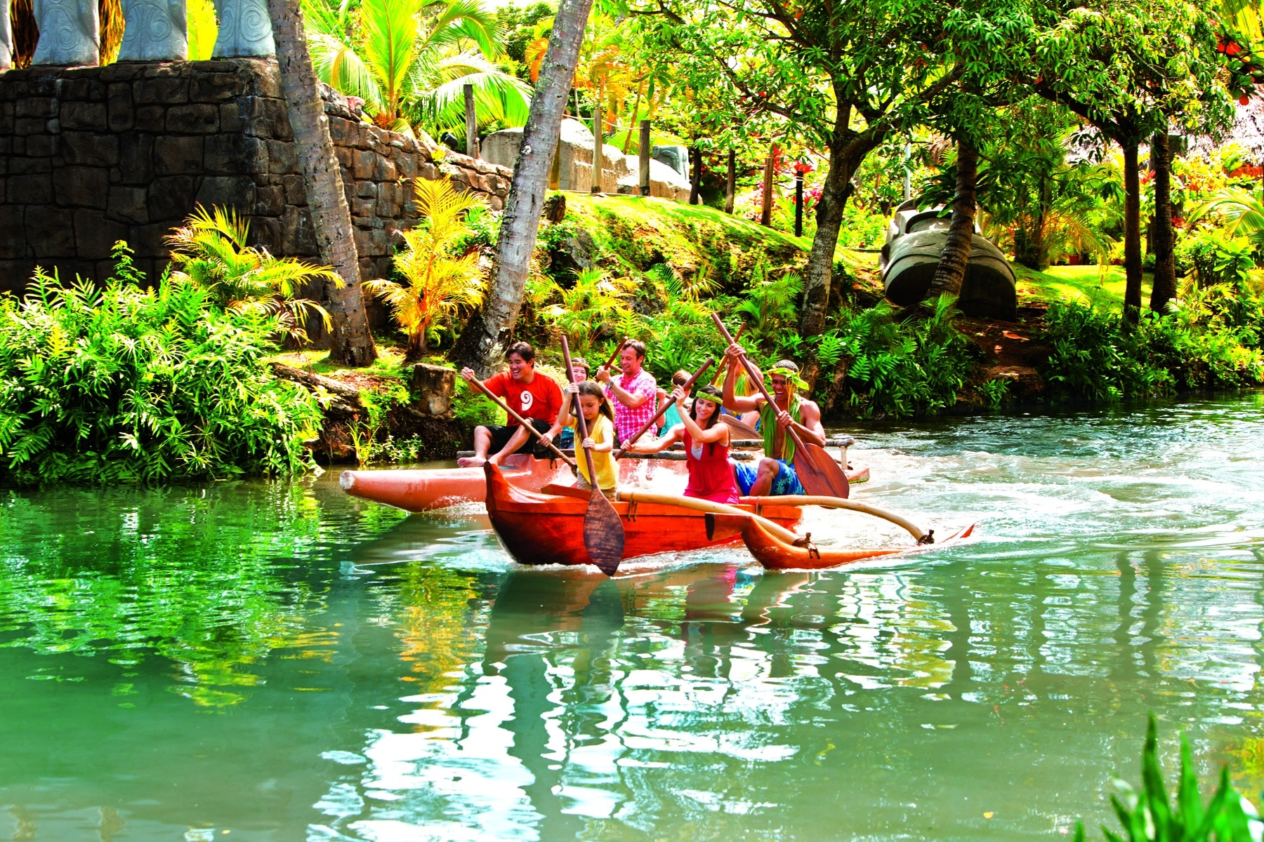 a tradtional boat is piloted over the waters of oahu