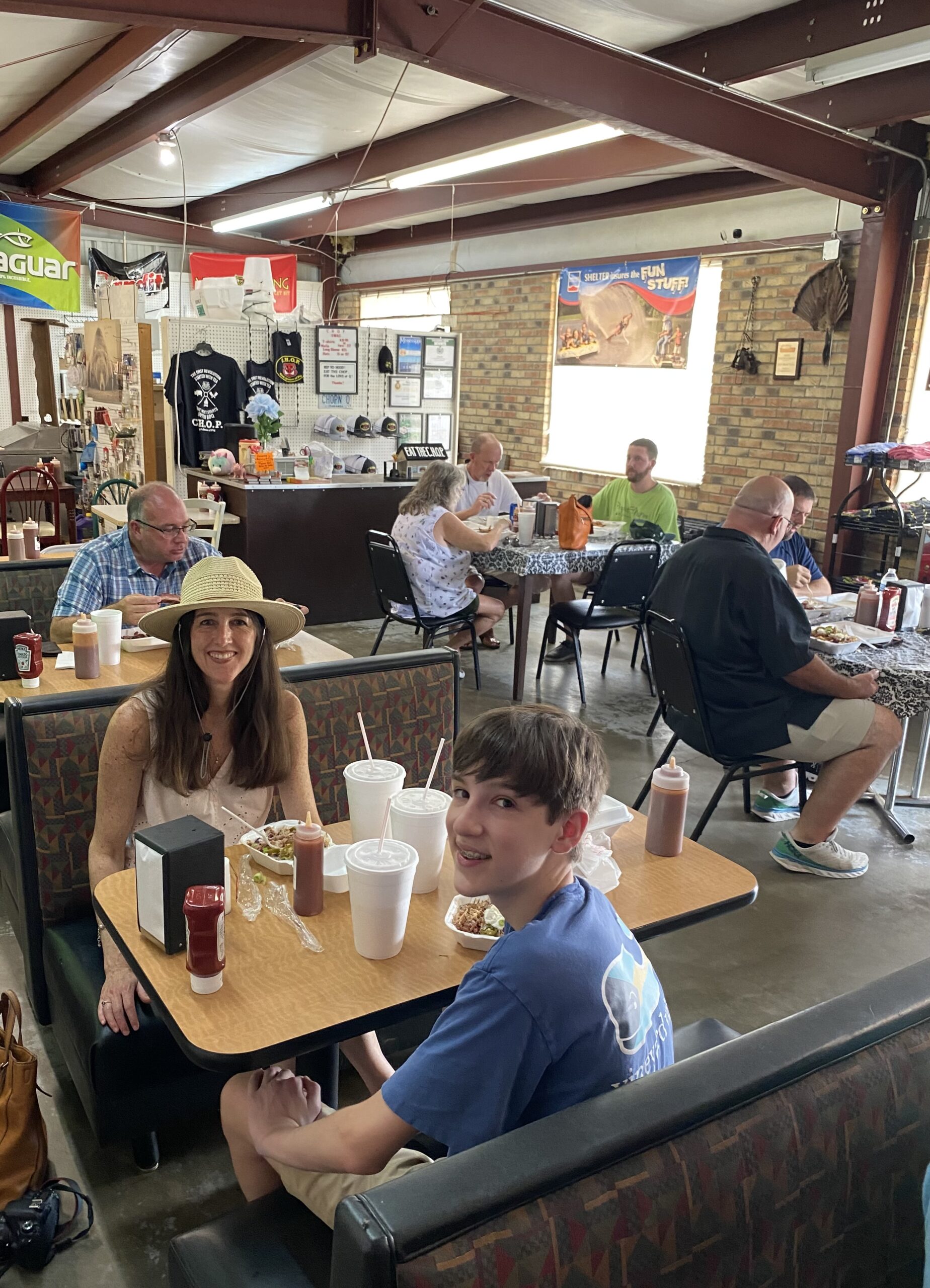 Woman and teen boy sitting at a booth at Clay's House of Pig in Tupelo MS