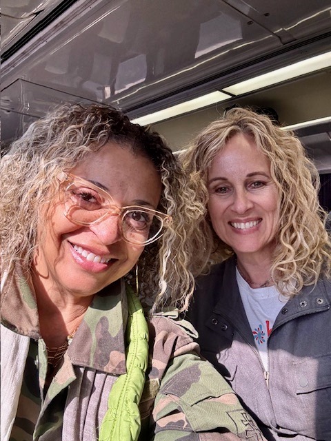 Two smiling women taking a selfie together.