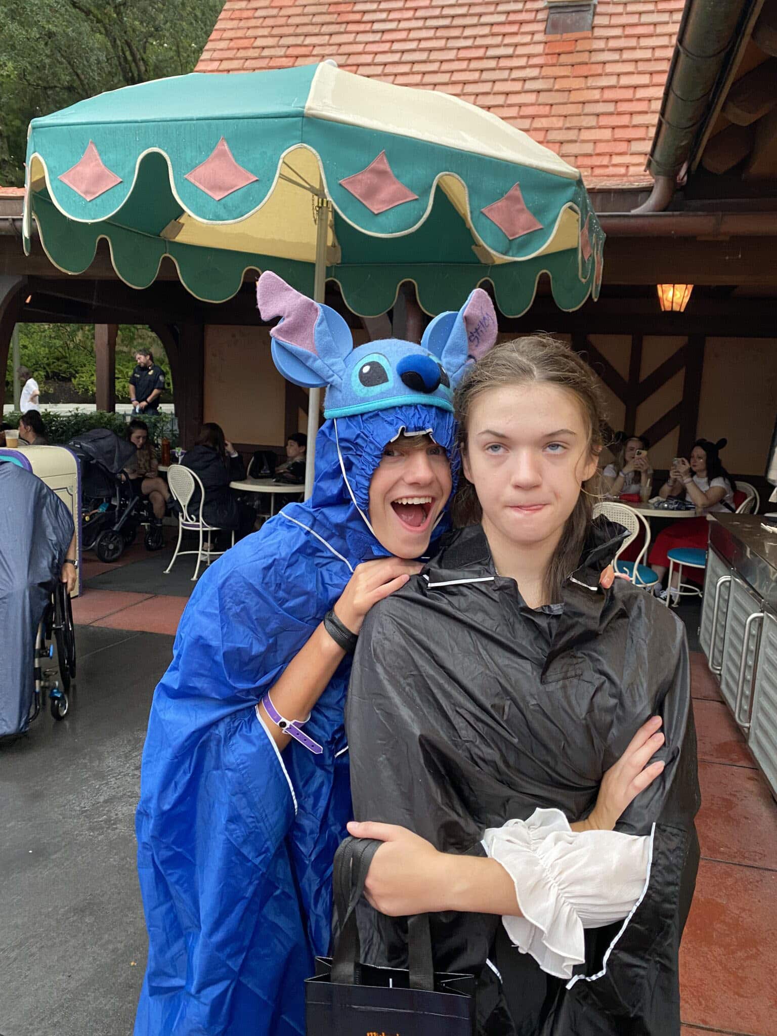 two kids prepared for rain at Disney's Not So Scary Halloween party