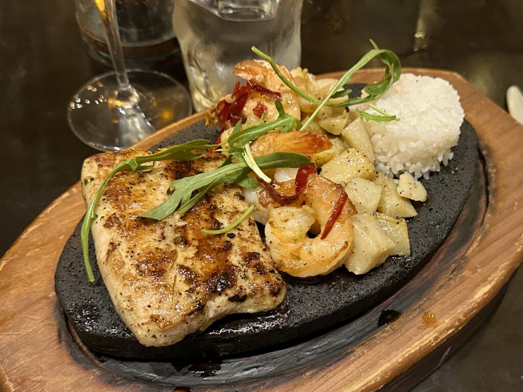 Mahi mahi and shrimp with rice and potatoes at Latino restaurant at Margaritaville Cancun in Mexico.