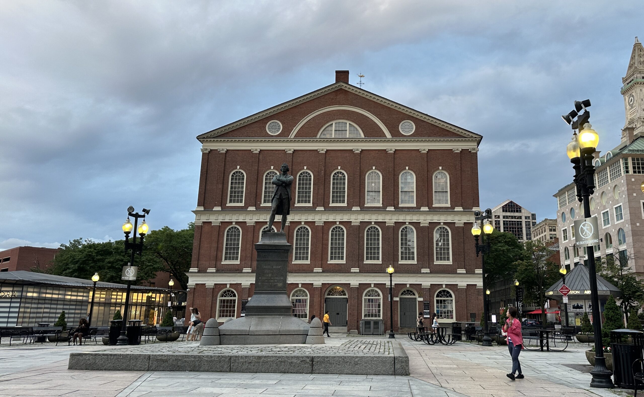 Faneuil Hall facade with Samuel Adams statue in front and modern Sephora building to the left.