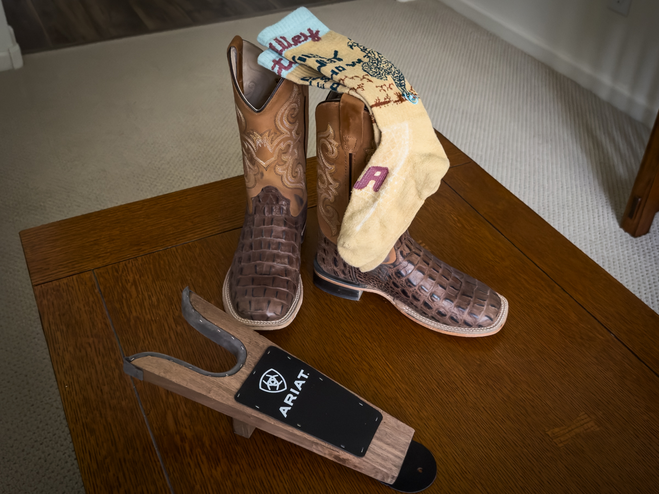 Cowboy boots, knee socks, and boot jack to remove boots.