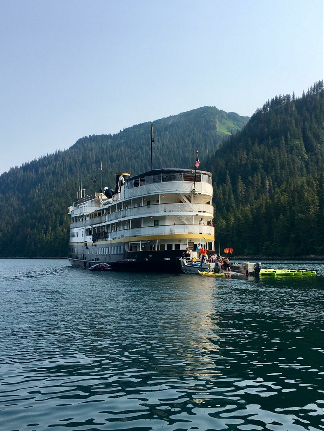 An Uncruise ship anchored in an inlet in Alaska