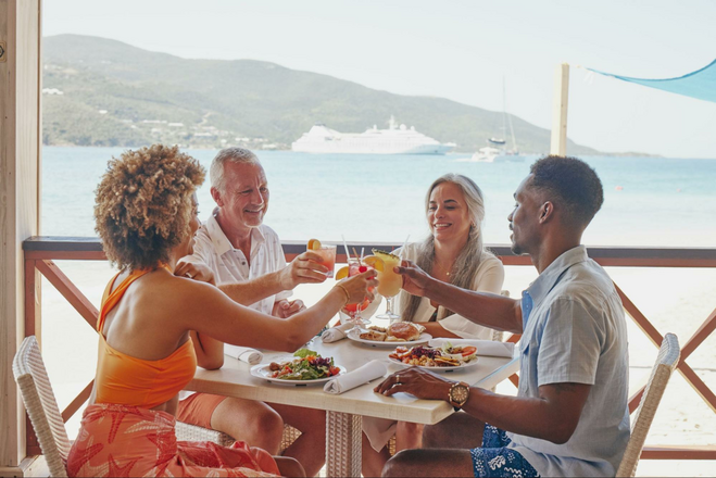 People toasting at meal on deck of Windstar Cruises ship