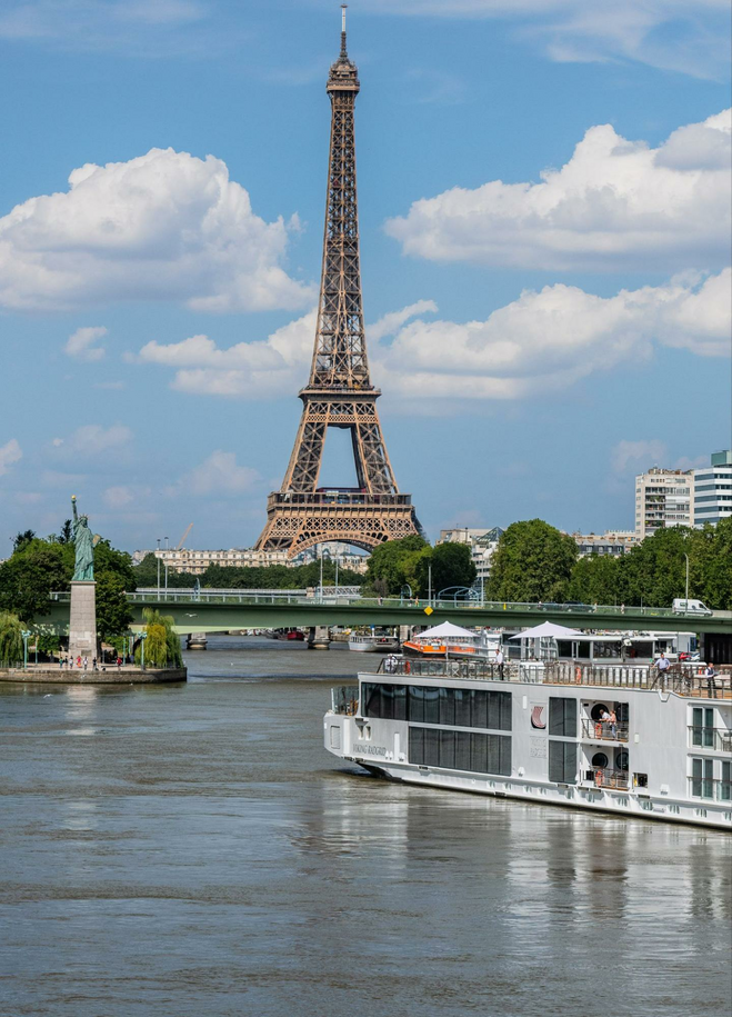River cruise ship sailing in front of Eiffel Tower