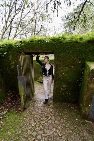 Hudson standing in green, leafy archway in Sintra, Portugal.