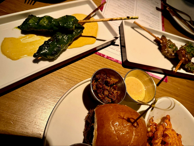 Several entrees on the table at Linger restaurant in Denver, CO.