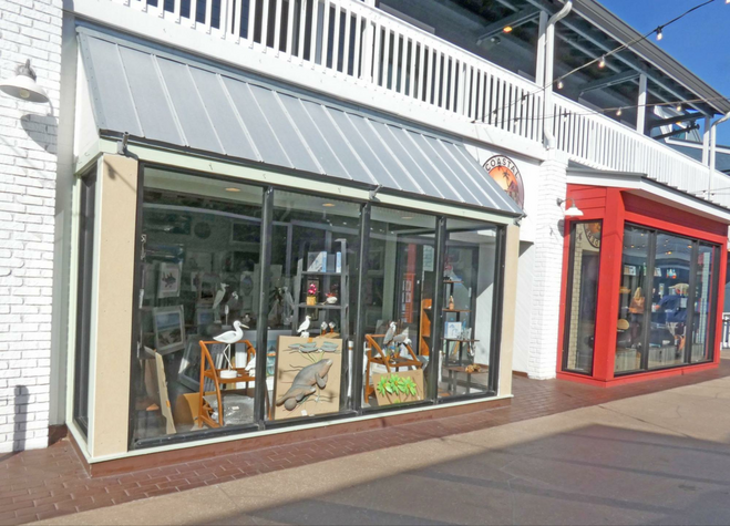 Two shop windows showing art in window.