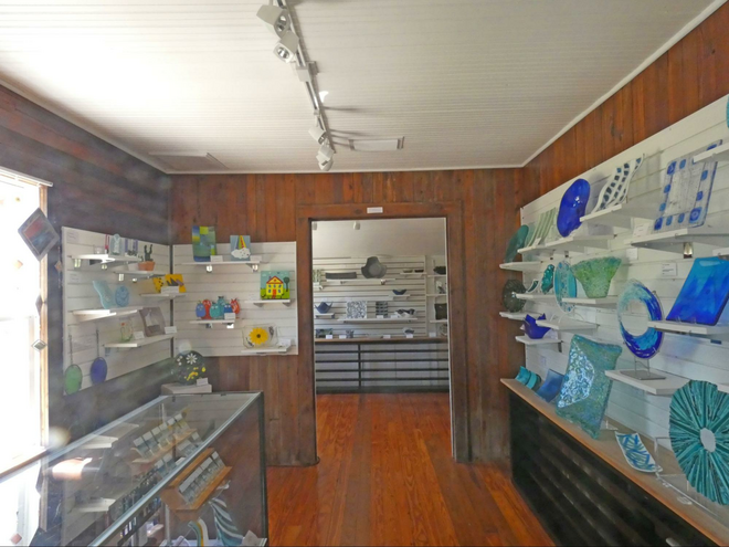 A glassware shop with glass items on shelves.