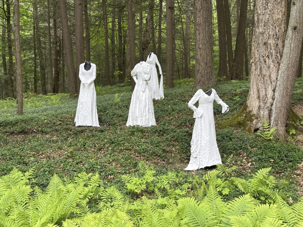 Ghostly Victorian white dress sculpture in the woods at The Mount.