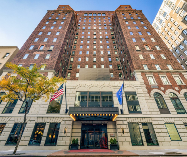 The Front Of NH Hotel NY Madison Avenue Manhattan rising up to the blue sky