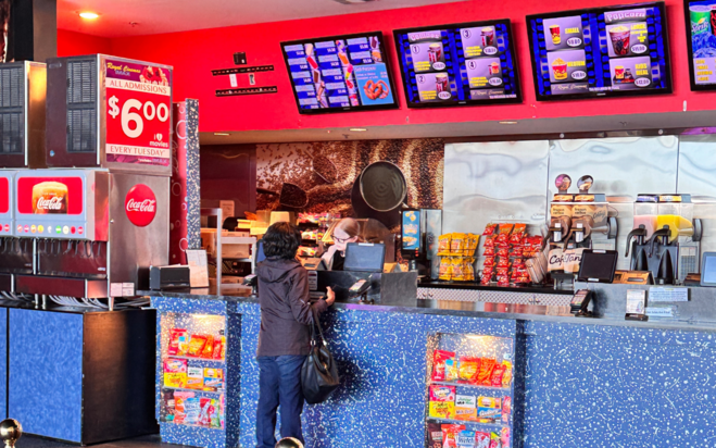 movie theater concession stand with woman ordering.