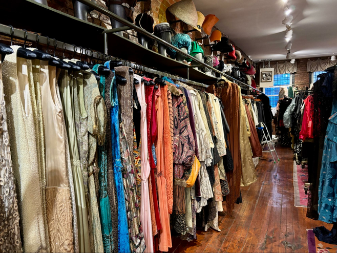 Store with vintage clothes, hats and jewelry on well-worn wood floors