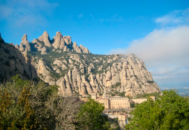 Monestary set into mountainside overlooking a valley