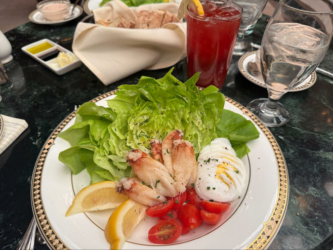 salad on fancy china plate with bibb lettuce lemon crab meat tomato and sliced hard-boiled egg