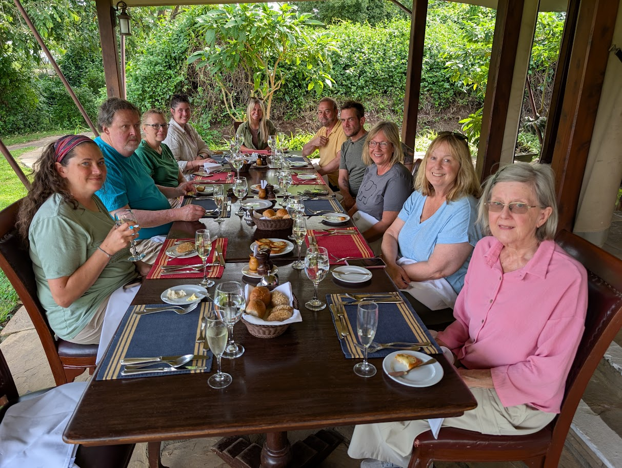 A group of safari travelers at dinner.