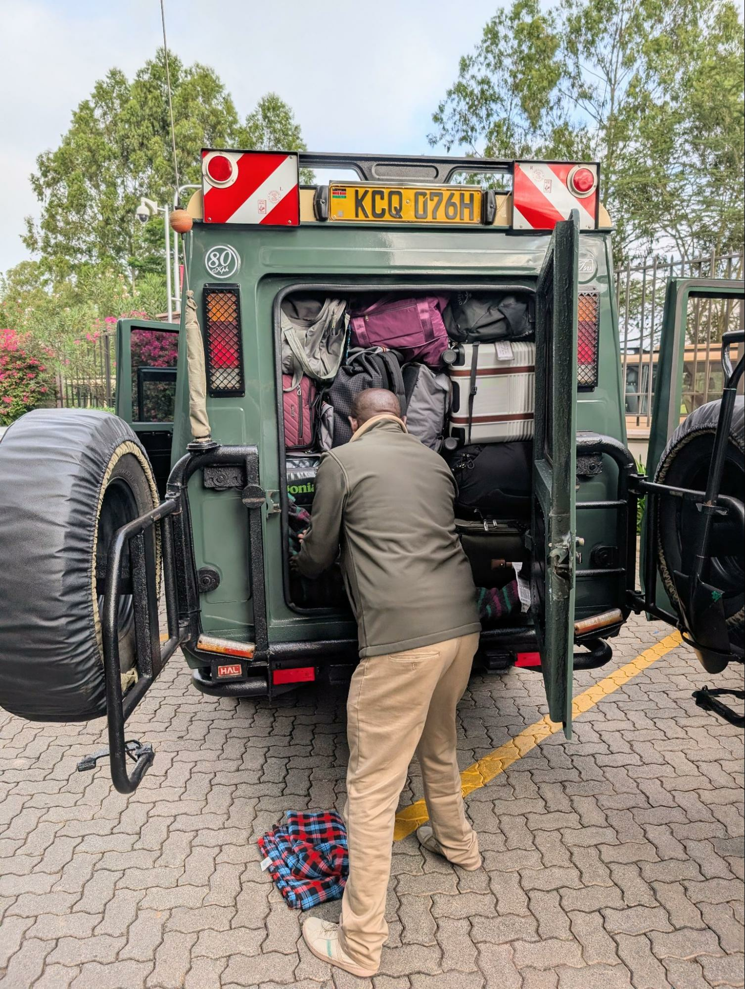 Safari guide packing the car with luggage