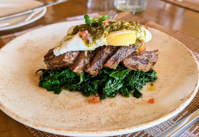 Beef with chimichurri topped with a poached egg and serve with sweet potato fries and wilted spinach -- a lunh option at the Surana Buffalo Springs hotel in Kenya