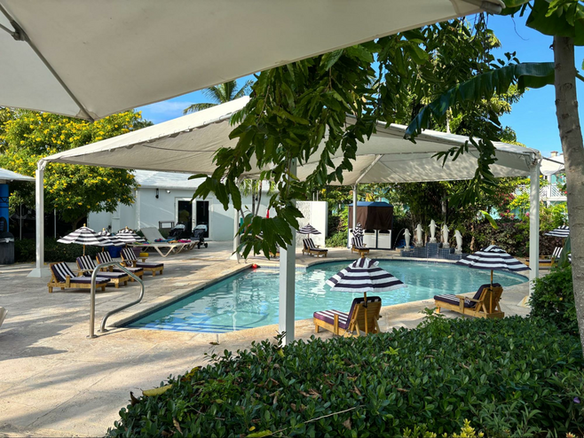 A view of Beaches all-inclusive resort’s baby pool surrounded by its own toddler-size striped chaise lounge and matching mini sun umbrellas.