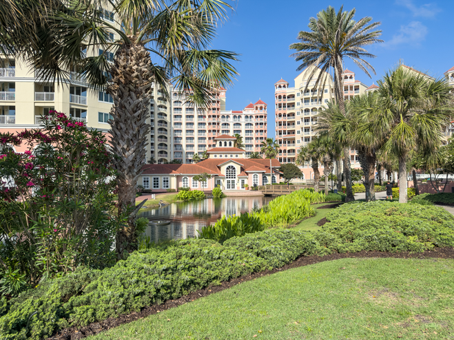Hammock Beach Resort on the lush grounds with reflections on the water.