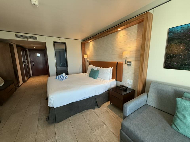 Hotel room with king sized bed and seating area.