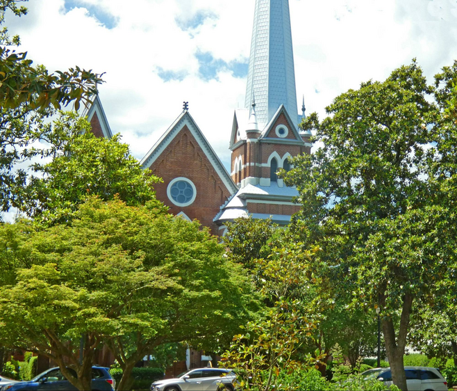 Red brick St. Mary Help of Christians Church with tall steeple
