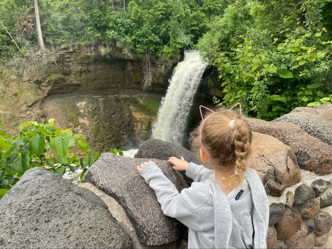 Girl overlooks Minnehaha Waterfalls in Minnesota