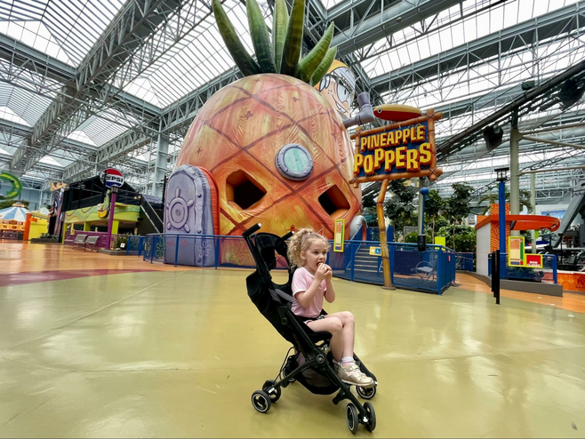 Girl sits in a stroller at Nickelodeon Universe at Mall of America