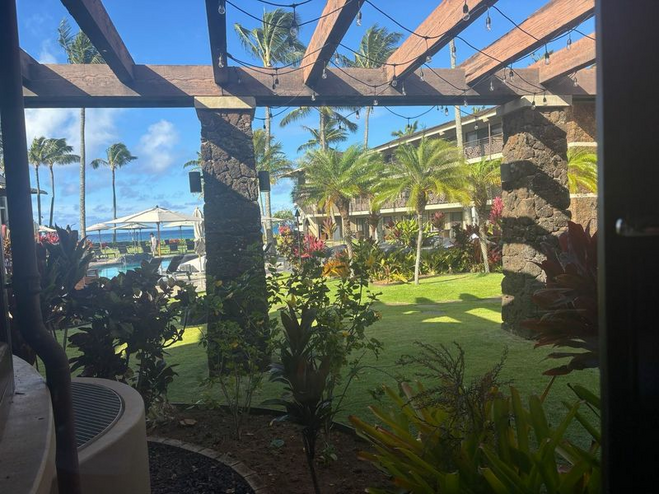 Outdoor patio area when dining at Red Salt Restaurant in Kauai showing lush greenery