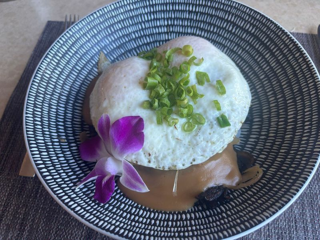 Loco meal meal with beef and flower on top at Red Salt Restaurant in Kauai