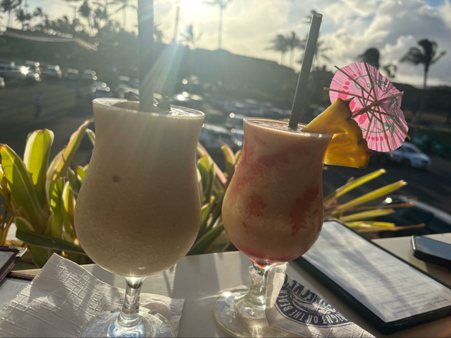 Two frozen cocktails with a view looking out from Brennecke’s Beach Broiler