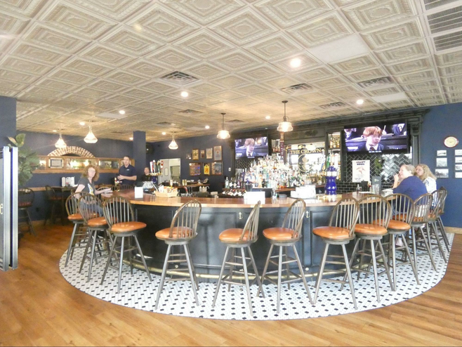 A circular bar with customers and waitstaff.