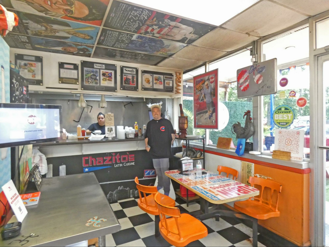 Chazito’s Latin Cuisine with bright orage chairs and with a cutout of Guy Fieri.