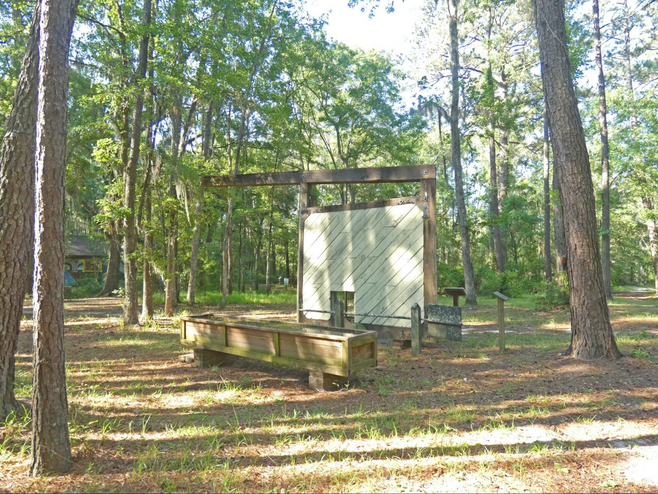 A replica of one of the canal locks in woods.