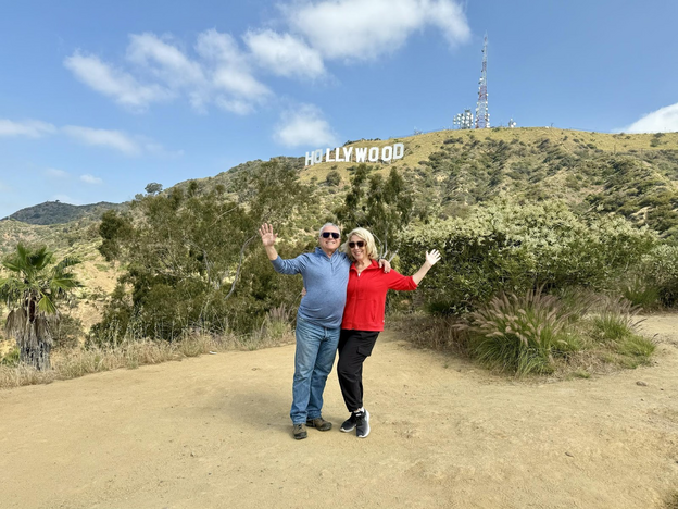 Author and husband on outlook looking up at Hollywood Sign