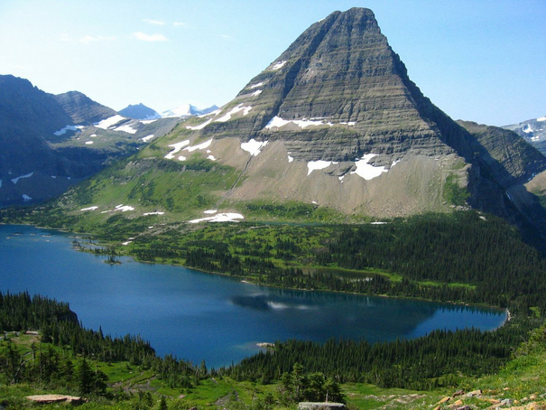 View over pristine Hidden Lske with rock mountain behind it.