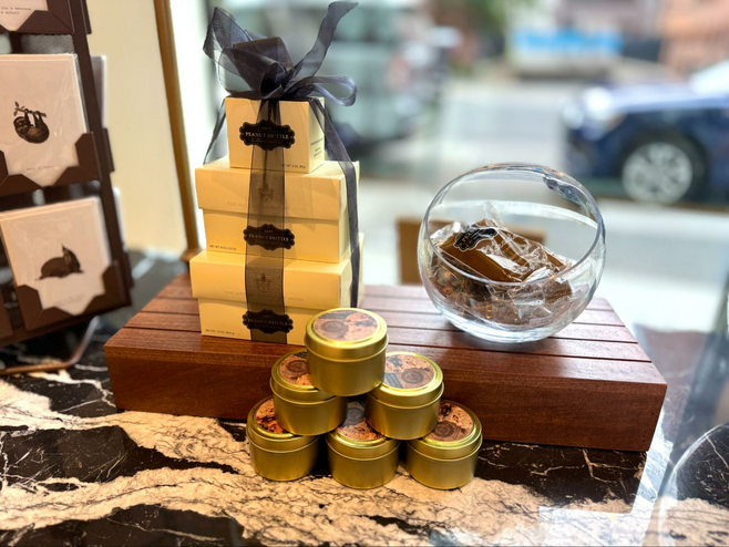 Window display of boxed candy, candles and cards