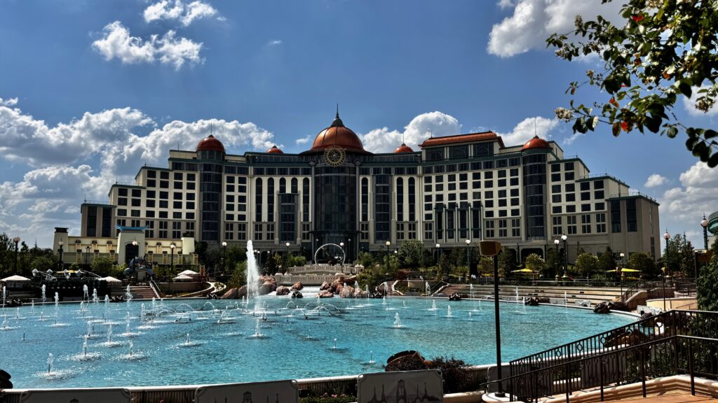 Frontal view of Helios hotel and enormous fountains in front.