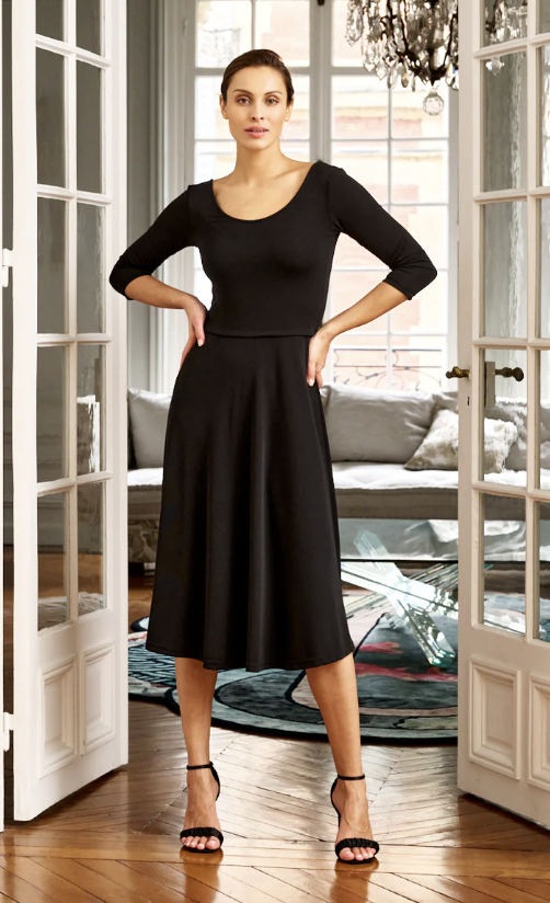 Woman wearing a scoop neck black knit midi dress