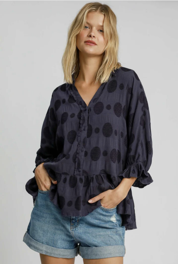 Blond woman wearing a boho Umgee charcoal gray blouse.