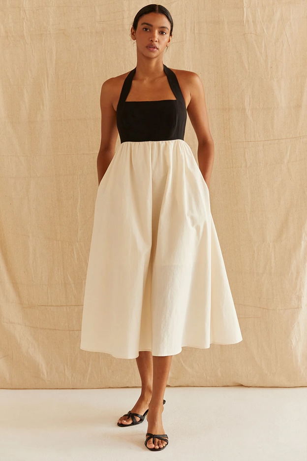 Woman wearing a mid-length ivory and black dress