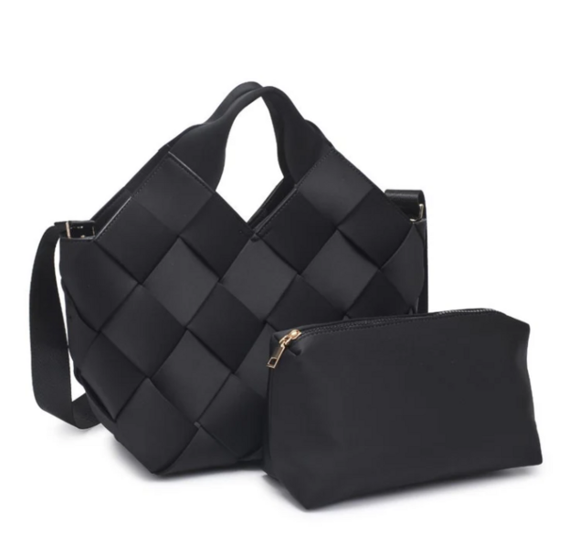 Product shot of a black woven tote bag and black toiletry bag